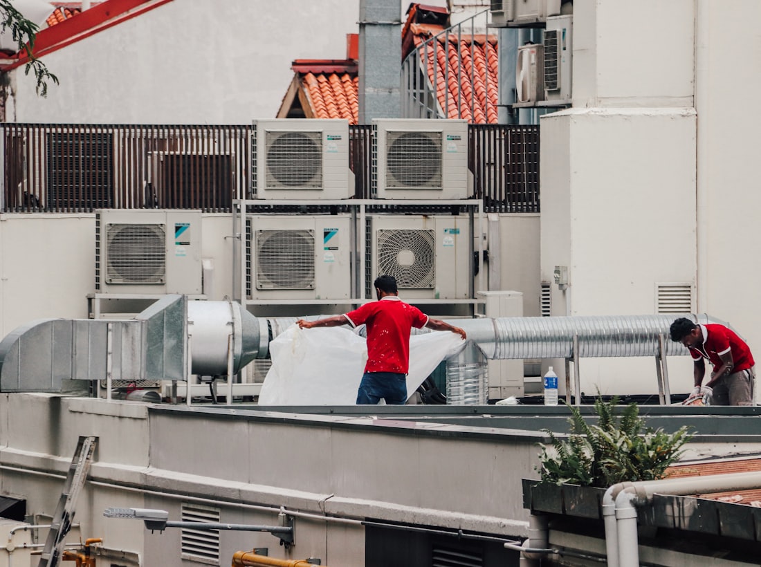 Al Sanad technicians servicing rooftop air-conditioning units